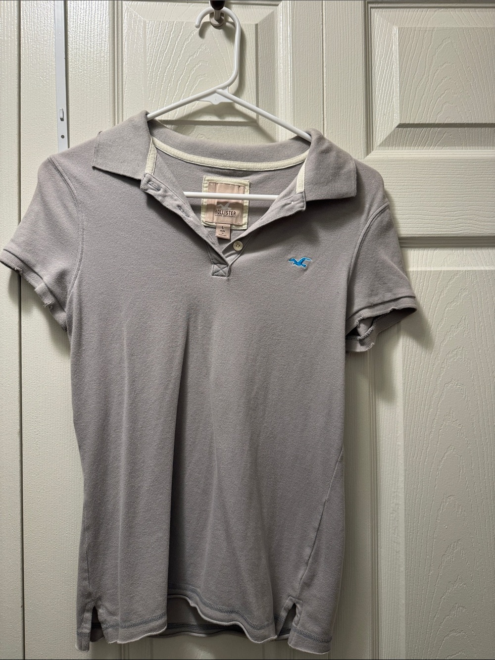 Hollister Women's Light Gray Polo with Blue Logo, size L. But it runs small.